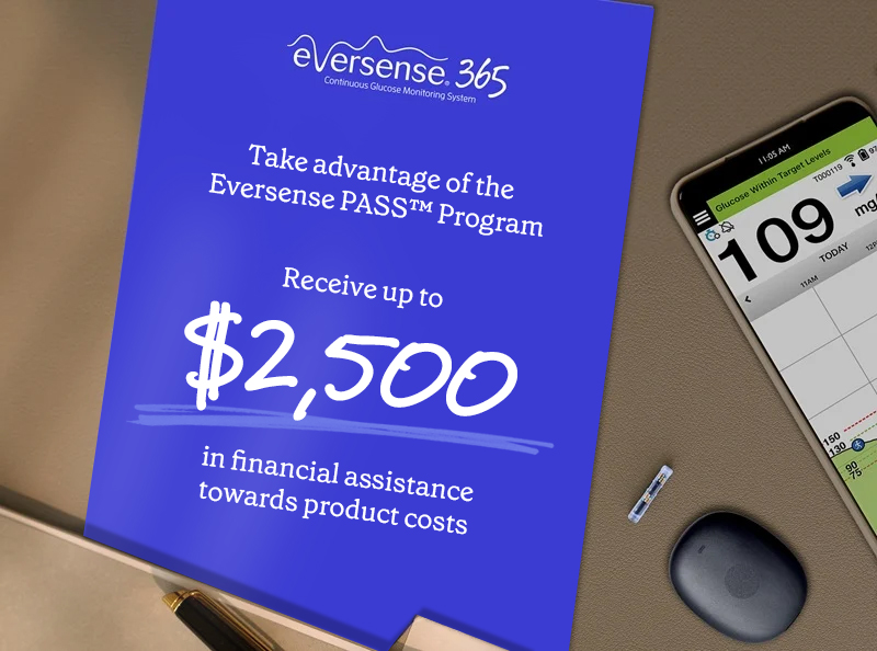 Eversense user smiling, flexing arm with a CGM sensor device attached, seated on a blue chair.