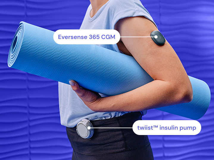 Eversense user smiling, flexing arm with a CGM sensor device attached, seated on a blue chair.
